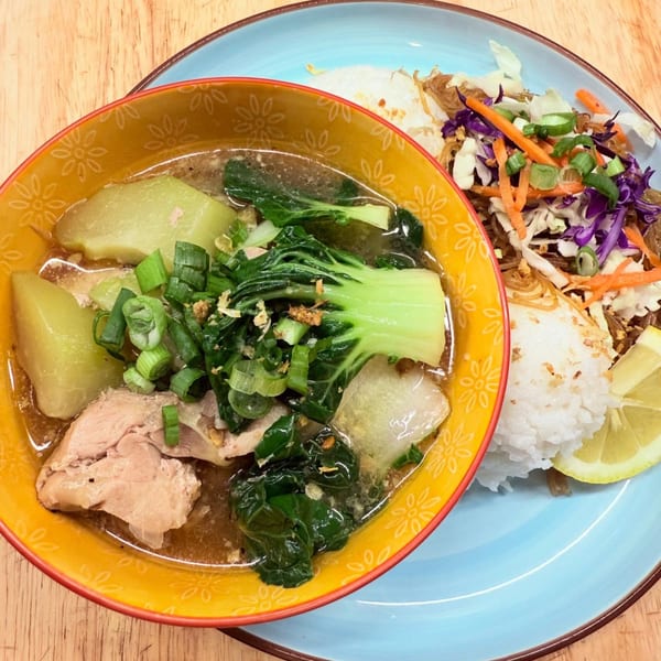 Filipino Tinola soup with chicken, bok choy, and chayote, served with rice and a side salad.